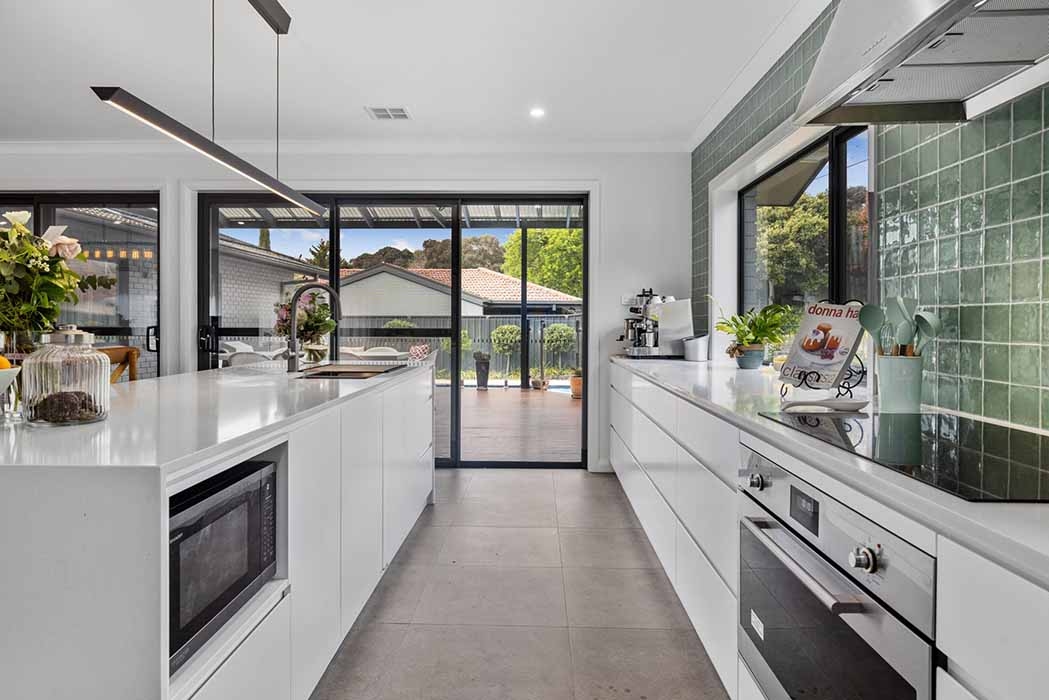 Modern kitchen with custom cabinetry and stone benchtops
