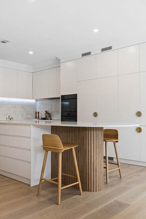 Modern kitchen renovation in Canberra, Australia with wooden island and sleek cabinetry.