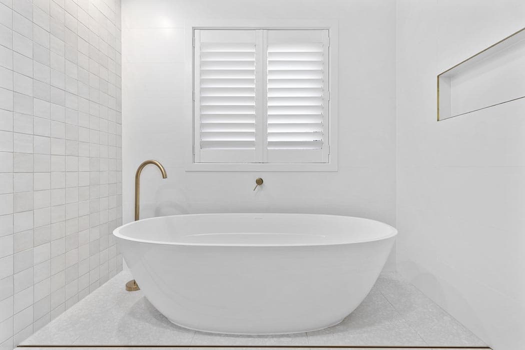 Modern bathroom renovation in Canberra with freestanding tub and elegant finishes.