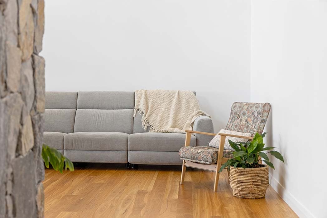 Modern living room design in Canberra, Australia with stylish furniture and warm timber flooring.