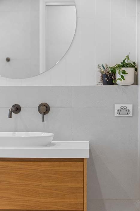Modern bathroom renovation in Canberra, Australia with sleek finishes and natural elements.