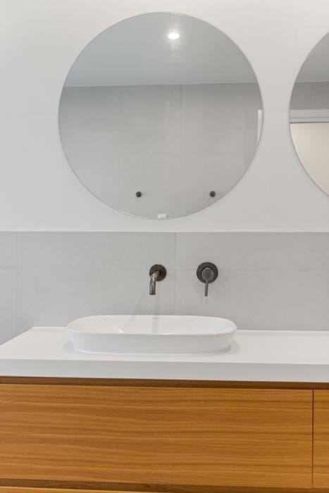 Modern bathroom renovation in Canberra, Australia with stylish fixtures and warm timber finishes.