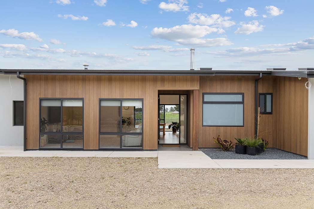 Modern home renovation in Canberra, Australia with timber cladding and large windows.