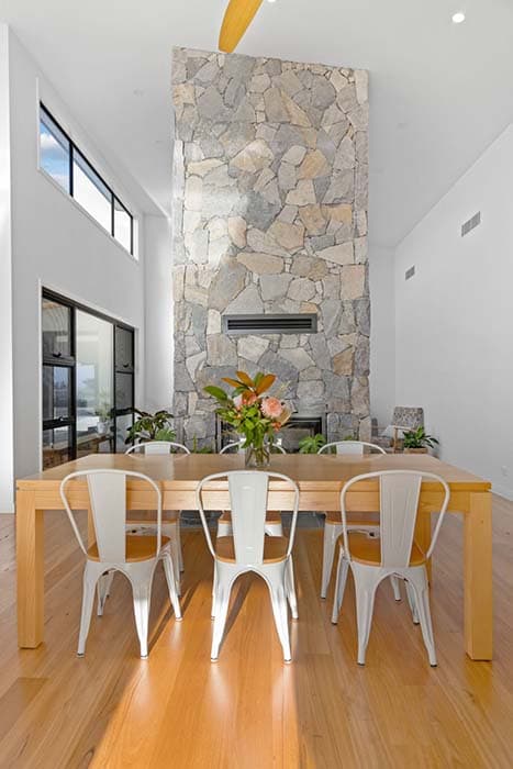 Modern dining area with stone wall in Canberra, Australia