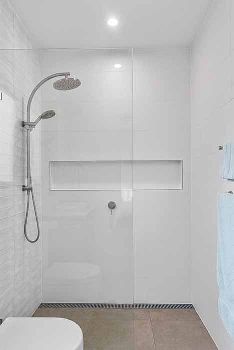 Modern bathroom renovation in Canberra with sleek glass shower and stylish finishes.