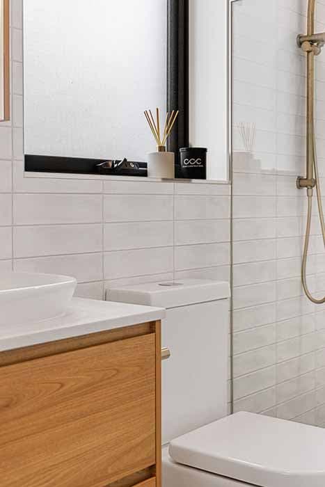 Modern bathroom renovation in Canberra, Australia with natural wood and white finishes.
