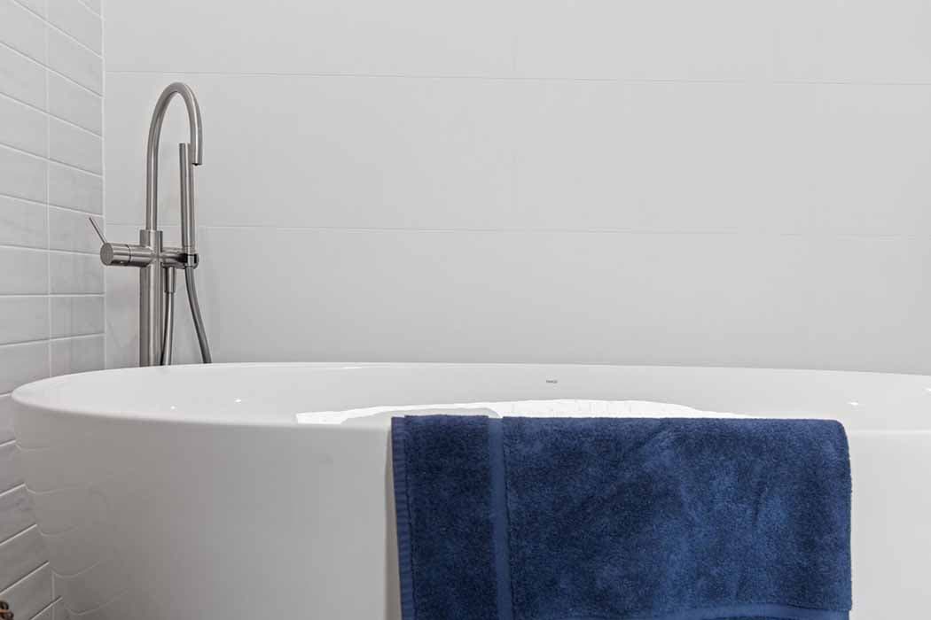 Modern bathroom renovation in Canberra with freestanding tub and sleek fixtures