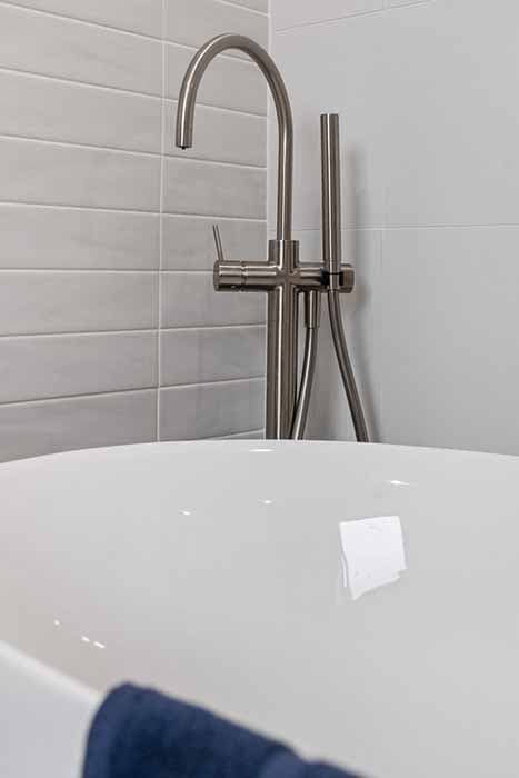 Modern bathroom renovation in Canberra with freestanding tub and sleek fixtures