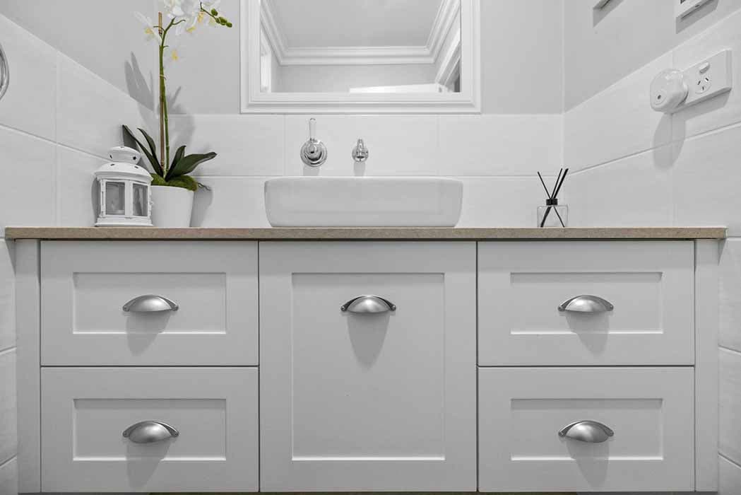 Modern bathroom renovation in Canberra, featuring sleek cabinetry and elegant fixtures.
