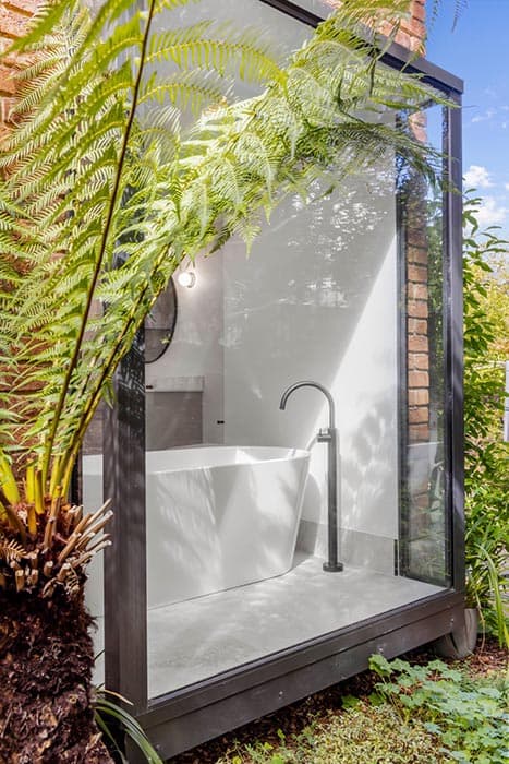 Modern bathroom renovation in Canberra with freestanding tub and glass enclosure