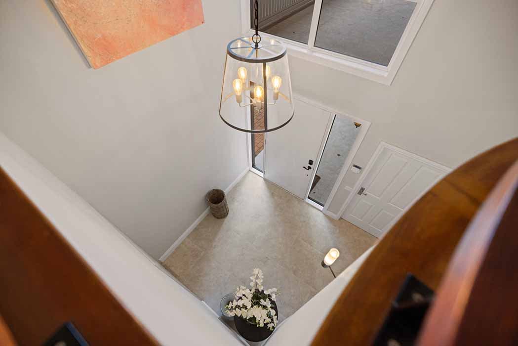 Modern entryway renovation in Canberra, Australia with elegant lighting and stylish decor.