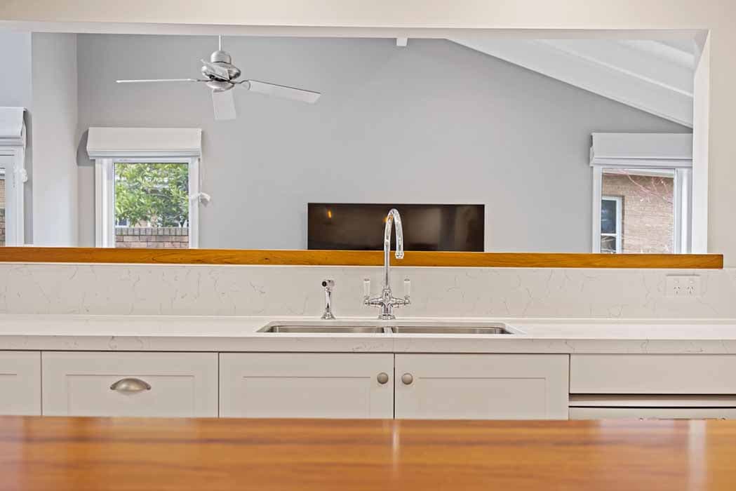 Modern kitchen renovation in Canberra, Australia with quartz countertops and natural light.