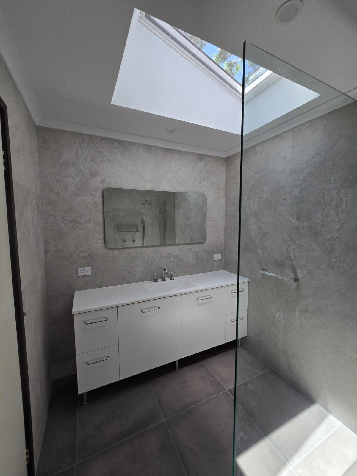Modern bathroom renovation in Canberra, featuring sleek design and natural light.