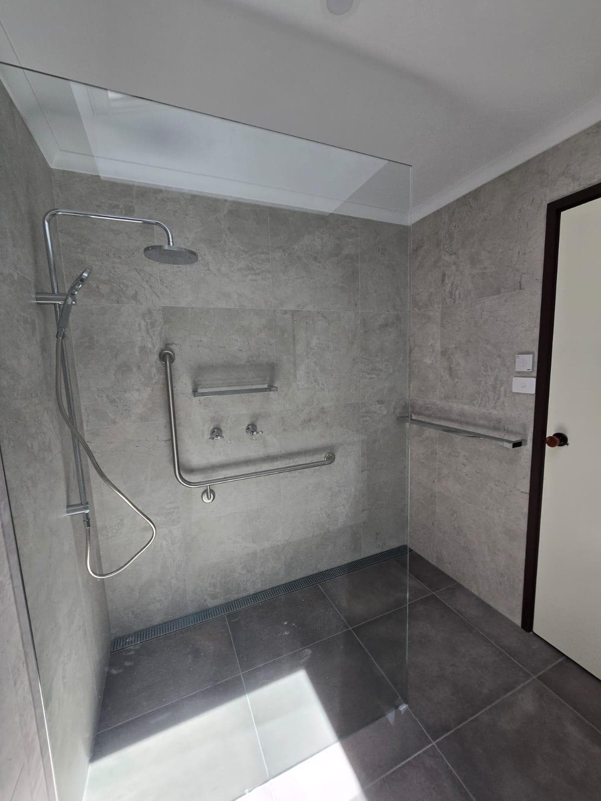 Modern bathroom renovation in Canberra with walk-in shower and sleek finishes