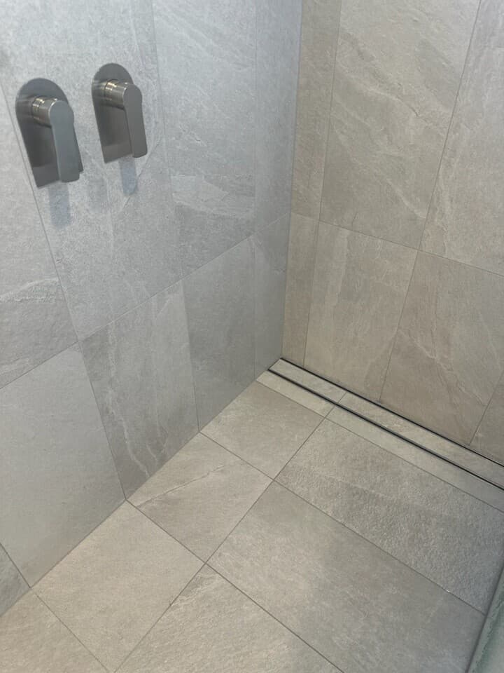 Modern shower renovation in Canberra, Australia with sleek tiles and fixtures.